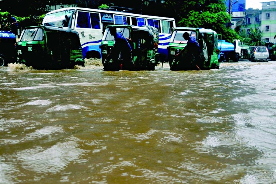 Hundreds of vehicles became stranded on different roads in the port city of Chittagong following incessant rains and onrush of hilly water. This photo was taken from WASA Square on Friday.