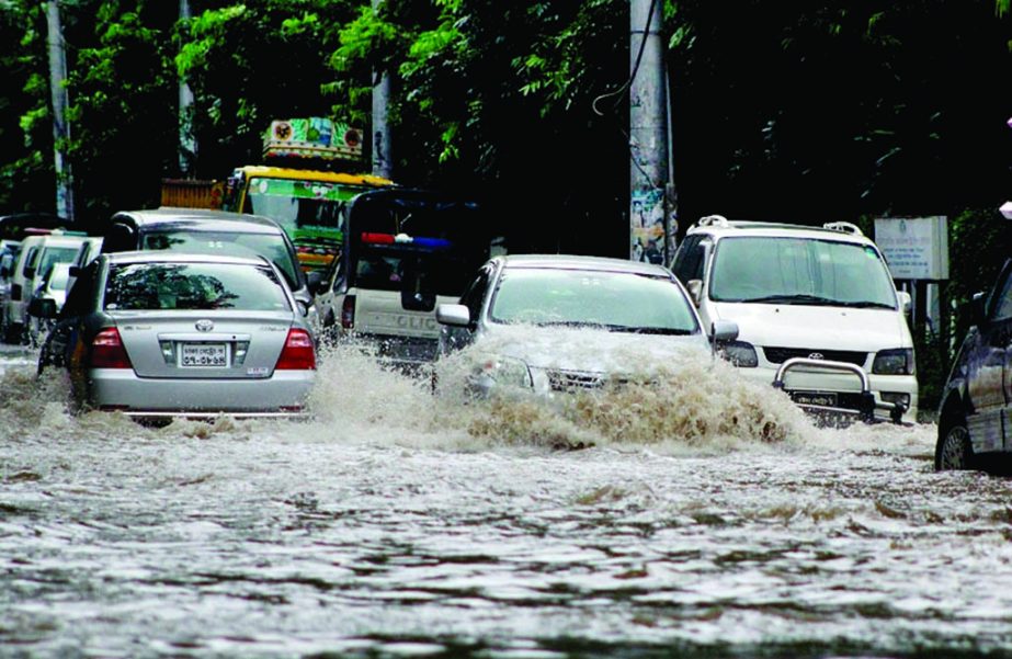 Motorised vehicles struggle through the stagnated rain water. The road was submerged due to heavy downpour. The snap was taken from the city's Mintoo road on Saturday.