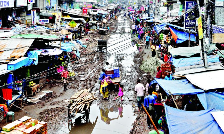Shanir Akhra Bazar Road in city is in bad shape for a long period causing immense sufferings to locals and shop owners on both sides of road. The photo was taken on Sunday shows people's hardship due to stagnant rain waters.