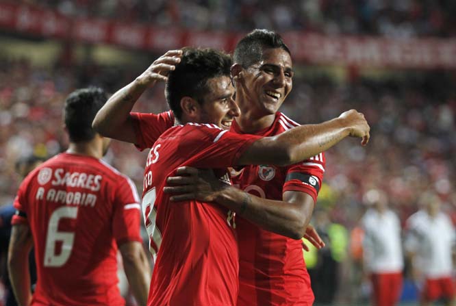 Benfica's Eduardo Salvio (centre) celebrates with teammate Franco Jara, both from Argentina, after scoring his side's second goal against Pacos Ferreira during the Portuguese league soccer match between Benfica and Pacos Ferreira at Benfica's Luz stad