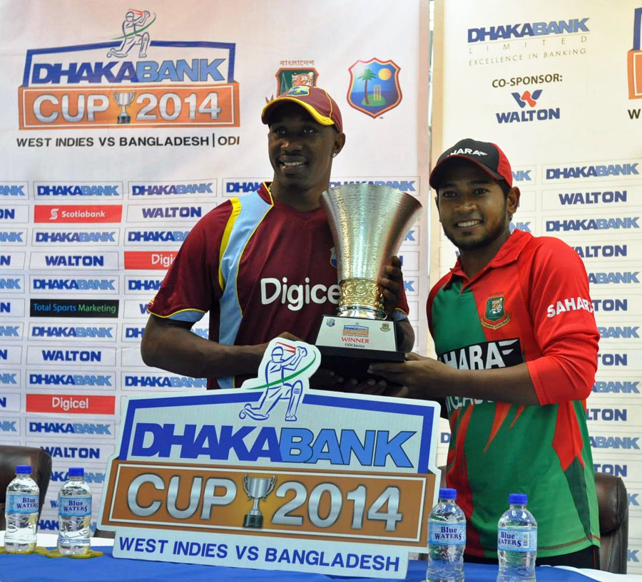 Dwayne Bravo and Mushfiqur Rahim pose with the ODI series trophy at Grenada on Tuesday.