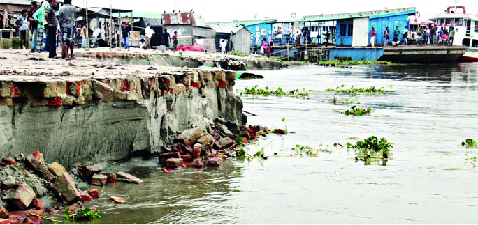 Vast areas of Mawa Ghat banks have been washed away and the terminal being separated due to onrush of flood waters affecting the movement of people of southern region of the country. This photo was taken on Wednesday.