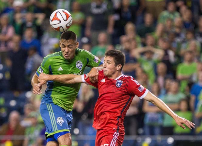 Seattle Sounders' Clint Dempsey heads the ball as San Jose Earthquakes' J.J. Kovall defends during an MLS soccer game on Wednesday in Seattle.