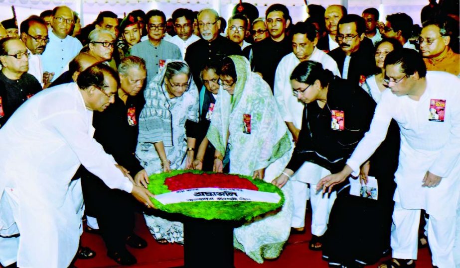 Prime Minister Sheikh Hasina with Cabinet colleagues, party leaders on Thursday placing wreaths at the â€˜temporary altarâ€™ in front of central office of Awami League at Bangabandhu Avenue marking the tenth year of the 21 August grenade attack.