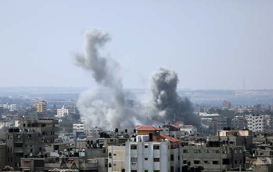 Smoke raises up in the sky following Israeli airstrikes in Gaza City.