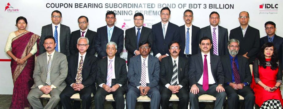 Faruk M Ahmed, Acting Managing Director of City Bank and Selim R F Hussain, Managing Director of IDLC Finance Ltd and senior executives of subscriber banks and financial institutions, posing at the signing ceremony of a Coupon-Bearing Subordinated Bond of