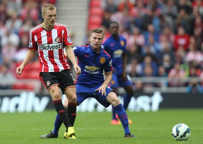Sunderland's Seb Larsson (left) vies for the ball with Manchester United's Tom Cleverley (right) during their English Premier League soccer match at the Stadium of Light, Sunderland, England on Sunday.