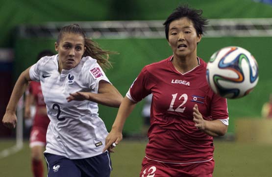 France's Eve Perisset (left) and North Korea's Jon So Yon run for the ball during the first half of a FIFA U-20 women's World Cup soccer match for third place in Montreal on Sunday.