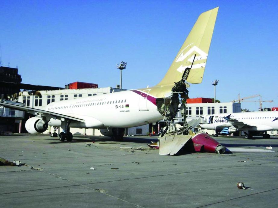 A damaged aircraft is seen after shelling at Tripoli International Airport August 24, 2014. Unidentified war planes attacked targets in Libya's capital Tripoli on Sunday, residents said, hours after forces from the city of Misrata said they had seized th