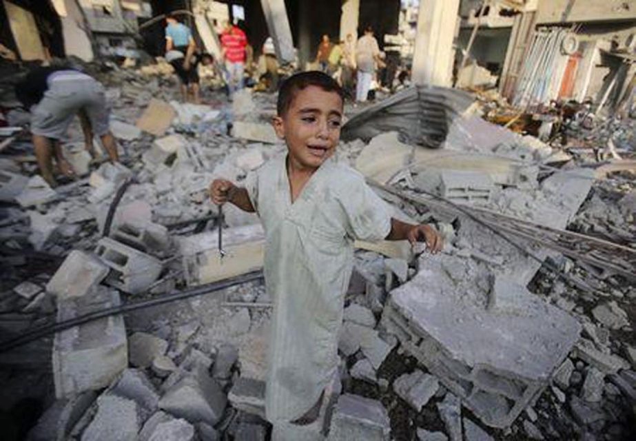 A Palestinian boy cries as he stands in a debris-strewn street near his family's house, which witnesses said was damaged by an Israeli air strike in Rafah in the southern Gaza Strip.