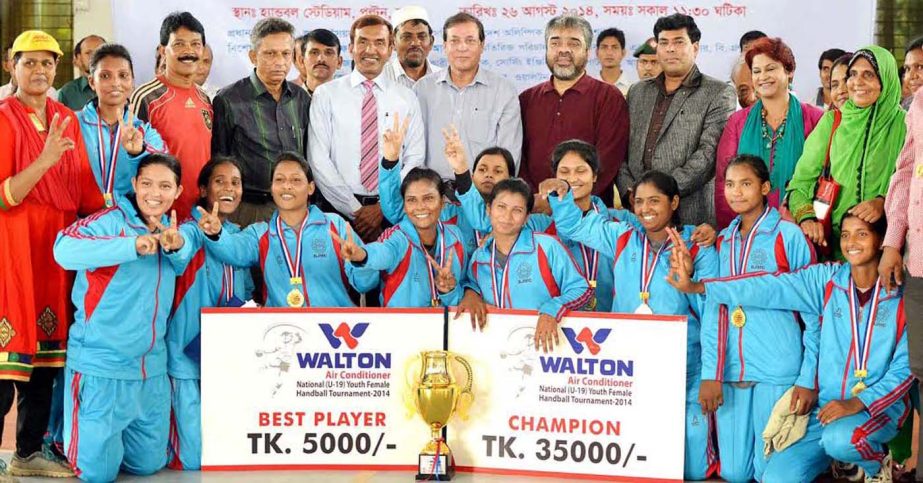 Members of BJMC, the champions of the Walton Air Conditioner National (U-16) Youth Female Handball Tournament with official of Bangladesh Handball Federation and guests pose for a photo session at the Shaheed (Captain) M Mansur Ali National Handball Stadi