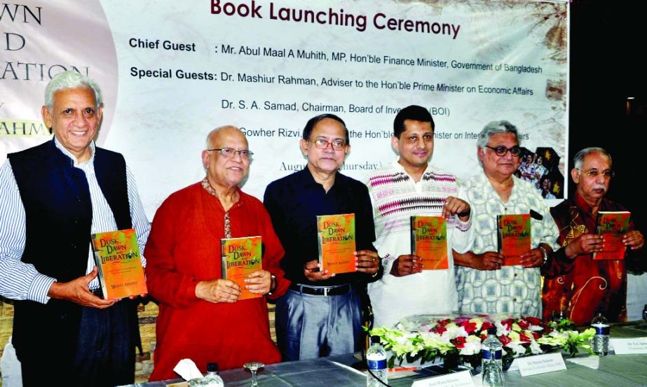 Finance Minister Abul Maal Abdul Muhith along with other distinguished guests holds the copies of a book titled 'Dusk, Dawn and Liberation' at its cover unwrapping ceremony at Dhaka Club in the city on Thursday night.