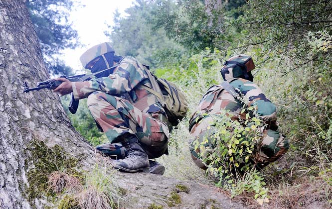 Army personnel taking position during an encounter with the militants at Baron Gali in Kalaro near the Line of Control (LOC) in Kupwara.