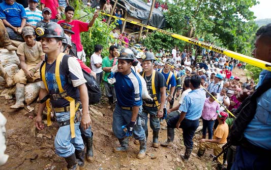 Miners walk in line as they enter the El Comal mine to help in the rescue operations at the gold and silver mine after a landslide trapped at least 24 miners inside, in Bonanza, Nicaragua.