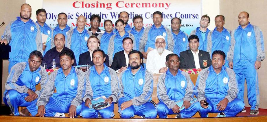 The participants of the wrestling coaches course pose for a photo session at the Auditorium of Bangladesh Olympic Association Bhaban on Saturday.
