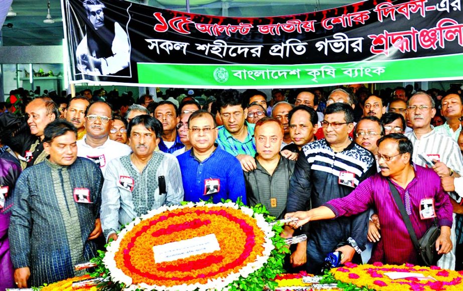 Md Abdus Salam, Managing Director of Bangladesh Krishi Bank, along with employees placed wreaths at the portrait of the Father of the Nation Bangabandhu Sheikh Mujibur Rahaman on the occasion of his 39th Death Anniversary and National Mourning Day at Dhan