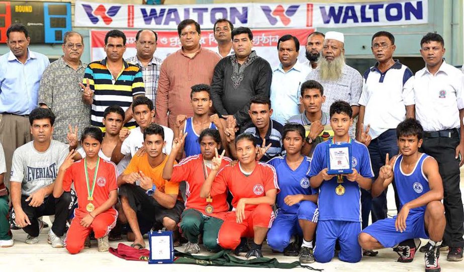 Bangladesh Ansar & VDP team, the champions of the Walton Refrigerator 13th National Intermediate Men's & 1st Women's Junior Boxing Competition with the officials of Bangladesh Boxing Federation and the guests pose for a photograph at the Muhammad Ali Bo