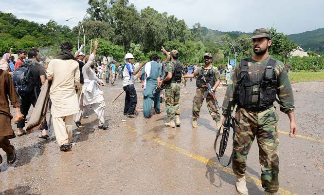 Army soldiers disperse protestors after clashes with anti-government demonstrators and police near the prime minister's residence in Islamabad on Monday.