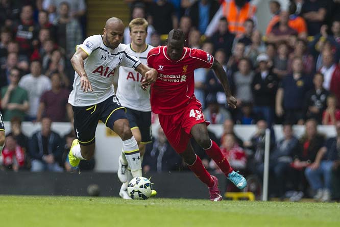 Tottenham Hotspur's Younes Kaboul vies for the ball with Liverpool's Mario Balotelli during their English Premier League soccer match at White Hart Lane, London on Sunday.