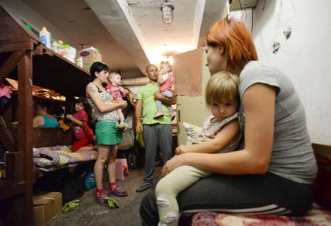 Families with children hide in the bomb shelter in Petrovskiy district in Donetsk, eastern Ukraine on Monday.