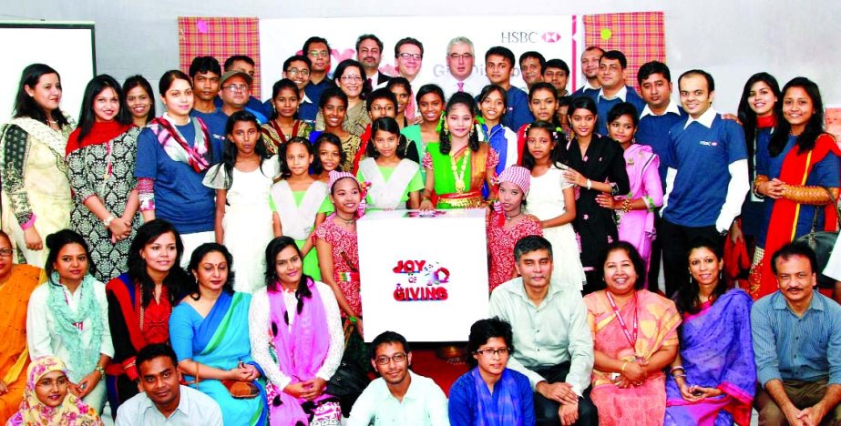 Volunteers from Hongkong and Shanghai Banking Corporation Limited and ActionAid Bangladesh distribute gifts among the disadvantaged children of ActionAid Bangladesh on the occasion of the bank's annual 'Joy of Giving' programme recently.