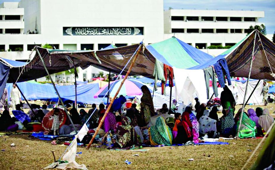 Supporters of Muslim cleric Tahir-ul-Qadri camp inside the vicinity of the parliament building in Islamabad, Pakistan on Tuesday. Pakistan's lawmakers held an emergency session Tuesday over the political crisis roiling the country as thousands of anti-go