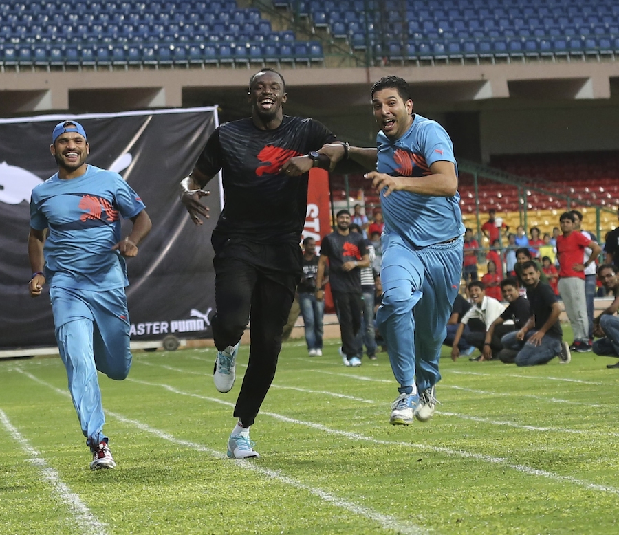 Yuvraj Singh pushes ahead of Usain Bolt in a friendly sprint at Bangalore on Tuesday.