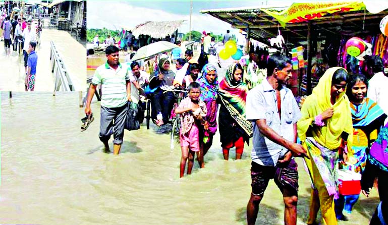 The both sides of the Trawler Ghat were inundated by the high tidal waters of Rupsha River in Khulna. This photo was taken on Wednesday.