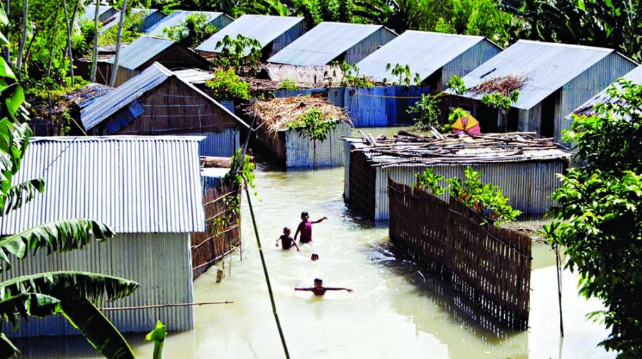 A cluster village on the bank of Isamati River was submerged by the flood waters of the river at Arhkatia of Dunote in Bogra. This photo was taken on Wednesday. Bangla Chokh