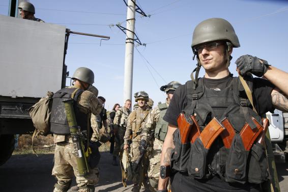 A heavily armed soldier of Ukrainian self-defence battalion 'Azov' walks at a check point in the southern coastal town of Mariupol September 4, 2014. CREDIT: REUTERSVASILY FEDOSENKO