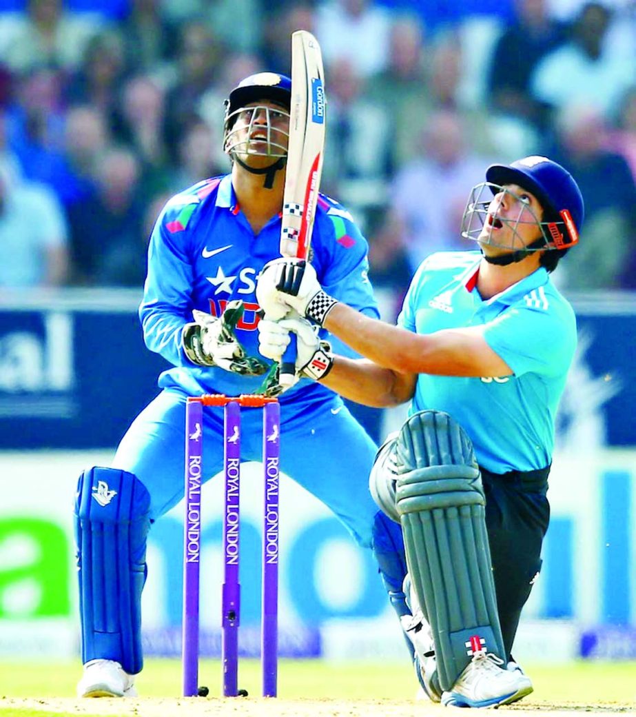 Alastair Cook and MS Dhoni look up as the ball takes the top edge during the Royal London One-Day match between England and India at Headingley in Leeds, England on Friday. England scored 294 for 7 in 50 overs.