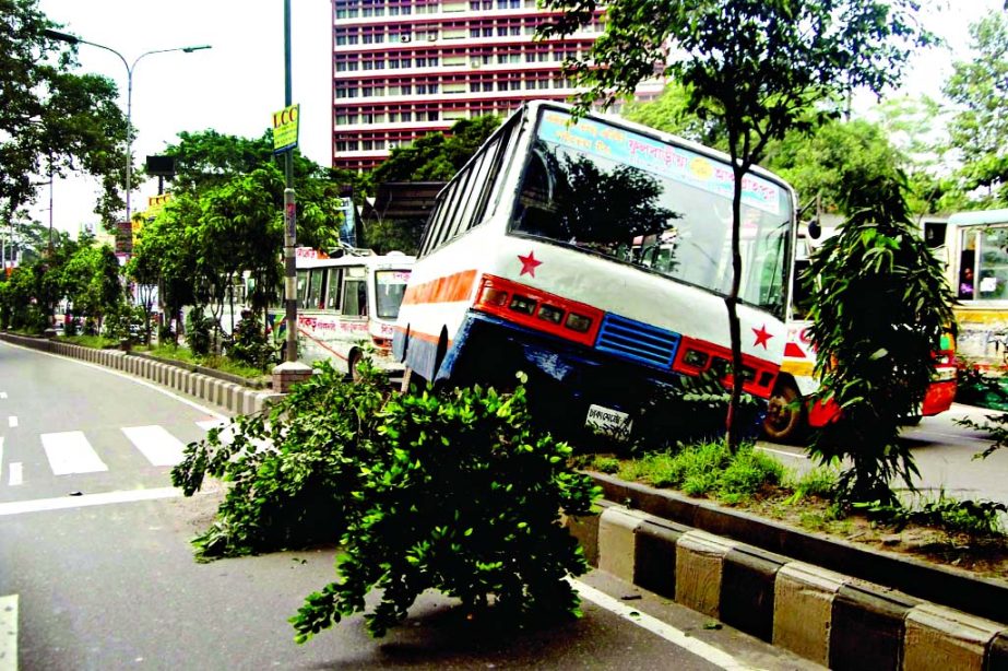 A passenger bus skidded off the road and hit the divider near city's Matshya Bhaban due to reckless driving on Friday.