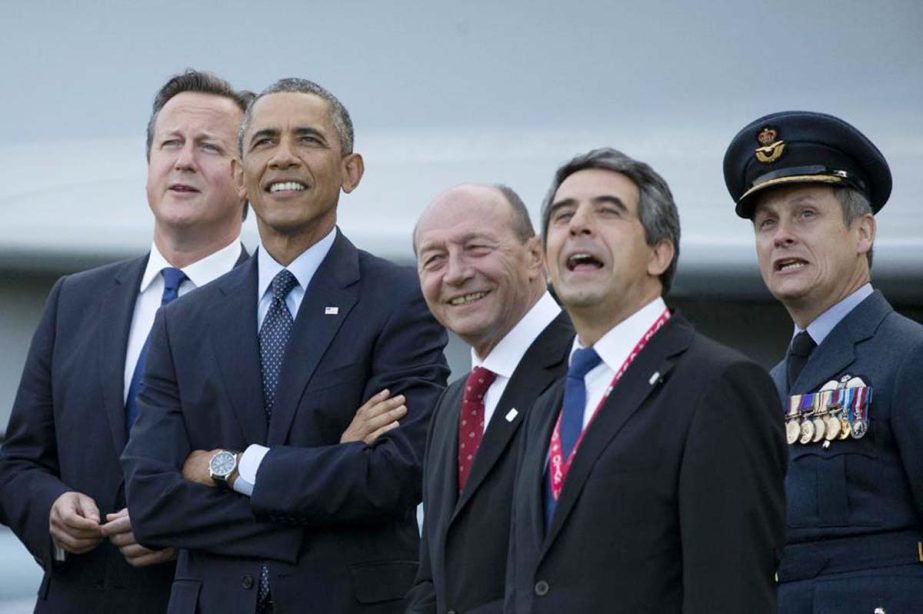 From left, British Prime Minister David Cameron, US President Barack Obama, Romanian President Traian Basescu, Bulgarian President Rosen Plevneliev and British RAF Group Captain David Bentley watch a flypast on the second day of a NATO summit at the Celti