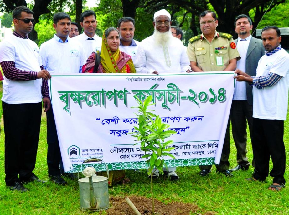 Director of Al-Arafah Islami Bank Limited Abdul Malek Mollah inaugurating 'Tree Plantation Activities-2014' with the slogan "Beshi kore gachh ropun korum, Sobuj bishwa gore tulun" at Mohammadpur & Lalmatia areas in the city recently.