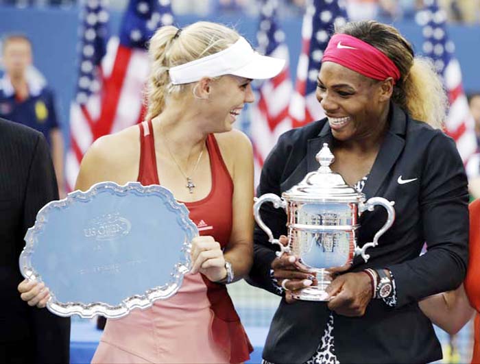 Caroline Wozniacki of Denmark (left) and Serena Williams of the United States pose for photos after Williams defeated Wozniacki in the championship match of the 2014 US Open tennis tournament in New York on Sunday.