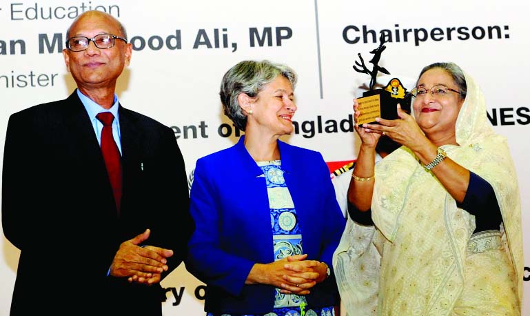 Prime Minister Sheikh Hasina receives â€˜Peace Treeâ€™ as memento from UNESCO Director General Irina Bokova on the occasion of International Literacy Dayâ€™ 14 at Bangabandhu International Conference Centre on Monday.