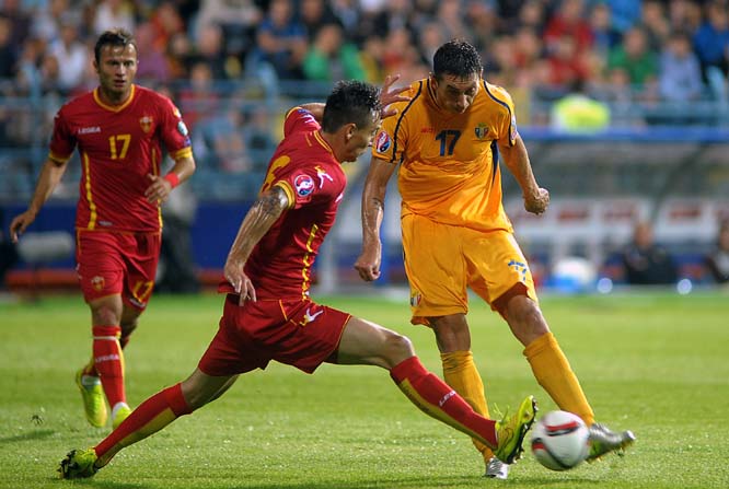 Montenegro's Zarko Tomasevic (left) fights for the ball with Moldova's Serghei Alexeev during the Euro 2016 qualifying match between Montenegro and Moldova at the City Stadium in Podgorica, Montenegro on Monday.