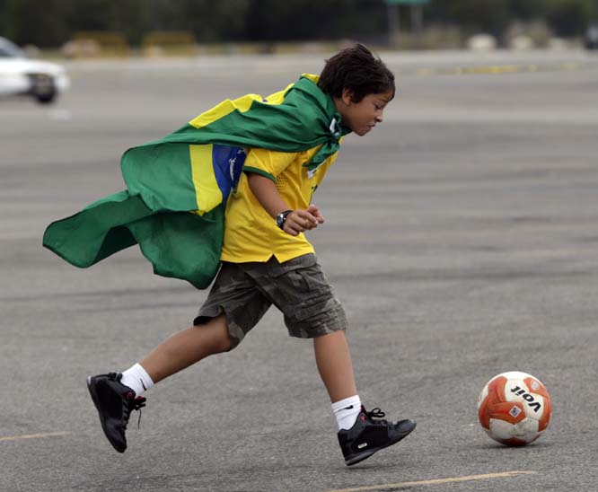 Kayo Leonardo, 8, of Westchester, NY runs with a soccer ball while waiting to enter MetLife Stadium for an international soccer friendly match between Ecuador and Brazil on Tuesday in East Rutherford NJ.