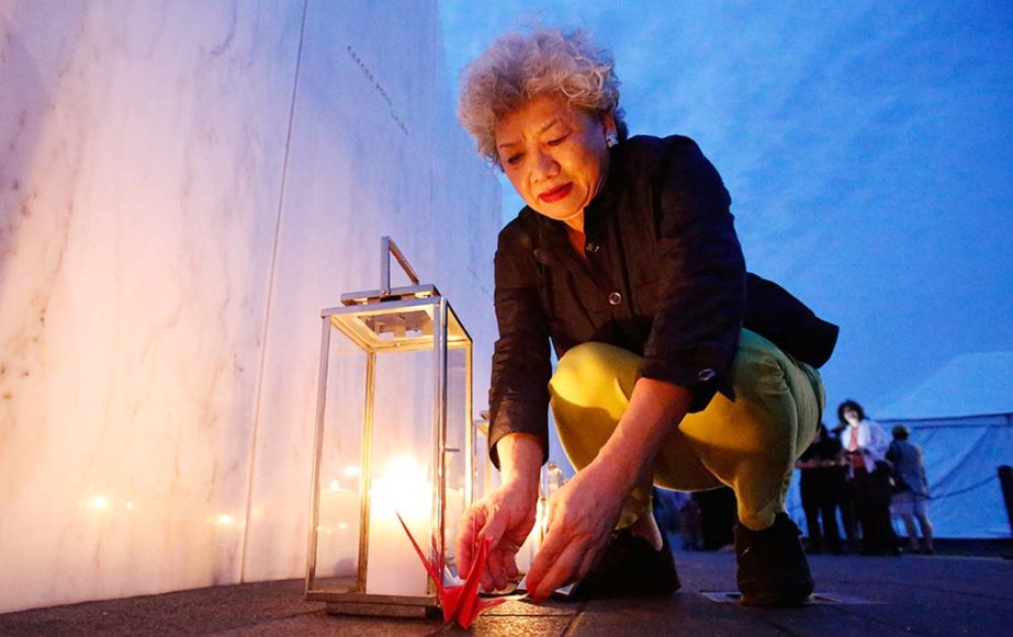 Yachiyo Kuge, A mother of 911 victims Toshiya Kuge who was a passenger on Flight 93, places origami birds near his name, at the Wall of Names at the Flight 93 National Memorial in Shanksville, Pa.. Thursday marks the 13th anniversary of the Sept. 11 terr