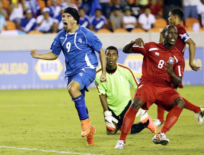 El Salvadorâ€™s Rafael Edgardo Burgos (9) celebrates after scoring his team's first goal as Belizeâ€™s Elroy Alexander Smith (8) and goalkeeper Woodrow West (center) watch during the second half of a 2014 Central American Cup soccer match in Ho