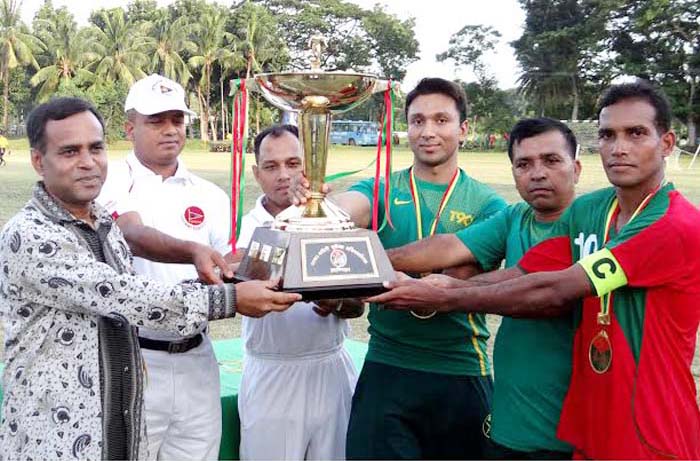 Commodore of Bangladesh Navy, Commanding Commodore of Khulna M Shaheen Iqbal handing over the trophy to Bangladesh Army team, which emerged champions of the Inter-Services Football Tournament at the Jessore Cantonment on Thursday.