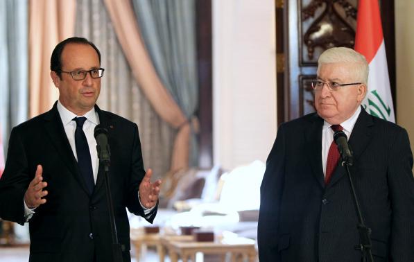 Iraq's President Fuad Masum (R) listens to his French counterpart Francois Hollande during their joint news conference in Baghdad September 12, 2014.