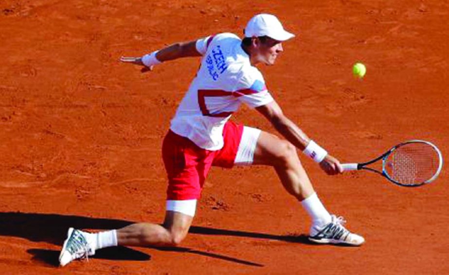 Tomas Berdych of the Czech Republic returns the ball against France's Richard Gasquet during their single match in the semifinal of the Davis Cup at the Roland Garros stadium in Paris on Friday.