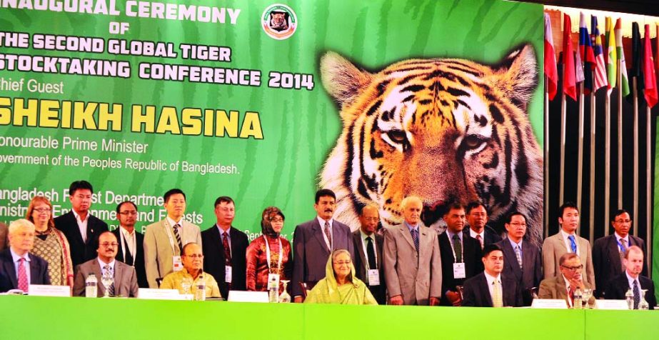 Prime Minister Sheikh Hasina poses for photograph with the organizers and distinguished guests at the Global Tiger Stocktaking Conference at a hotel in the city on Sunday.