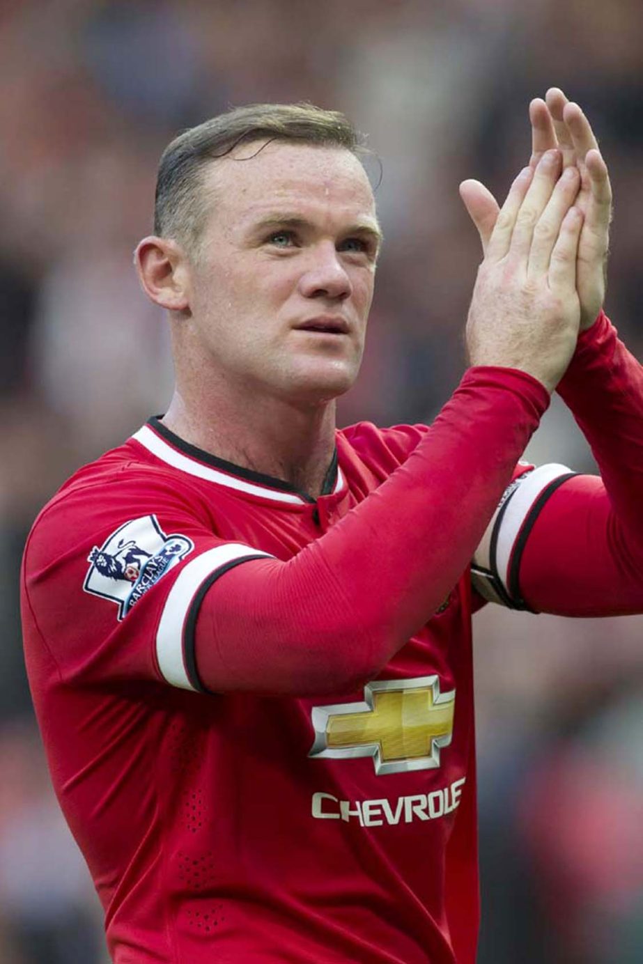 Manchester United's Wayne Rooney applauds supporters as he walks from the pitch after his team's English Premier League soccer match against Queens Park Rangers at Old Trafford Stadium, Manchester, England on Sunday.