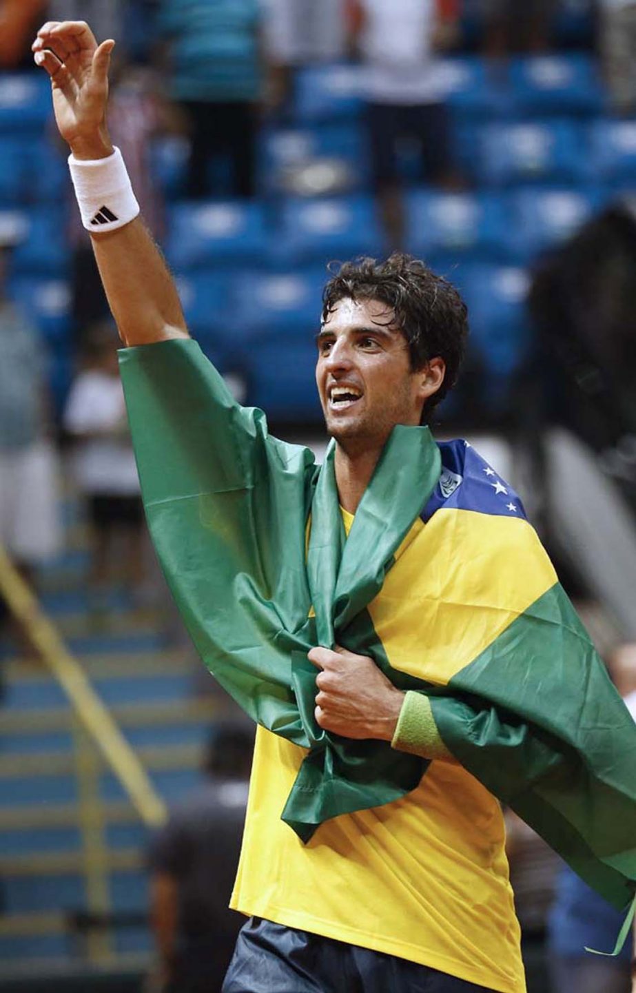 Thomaz Bellucci celebrates draped with the Brazilian flag after defeating Roberto Bautista Agut of Spain at the end of a singles tennis match of the Davis Cup World Group play-off in Sao Paulo, Brazil on Sunday. Brazil defeated the Spanish team 3-1 and ad
