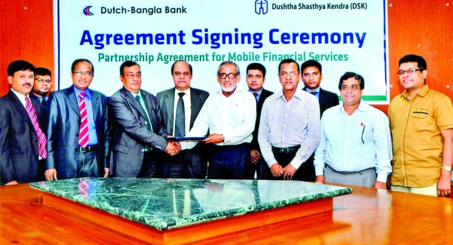 Masudul Quader, CEO of Dushtha Shasthya Kendra (DSK) and Md Abul Kashem Khan, EVP and head of mobile banking division of Dutch-Bangla Bank Limited sign an agreement to provide banking service to DSK's member at the bank's head office on Sunday.