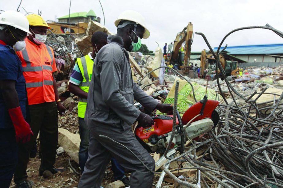 A rescue worker uses a chain saw as the search for survivors continues in the rubble of a collapsed building belonging to the Synagogue Church of All Nations in Lagos, Nigeria.