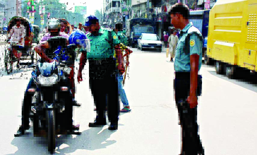 Law enforcers checking vehicles for security reasons during hartal called by Jamaat-e-Islami Bangladesh. The snap was taken from Palton area in the city on Thursday.