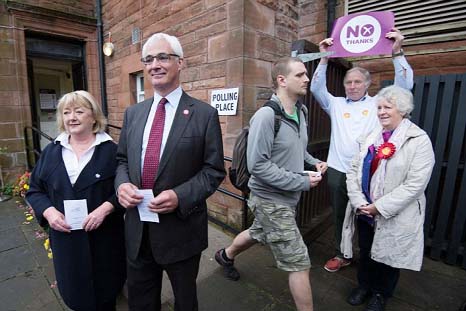 Former chancellor and leader of the Better Together campaign Alistair Darling and his wife Maggie, left, cast their vote at a polling station in Edinburgh